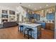 Open kitchen with custom cabinetry, a large island, and seamless access to the living area at 3973 Palmer Ridge Dr, Parker, CO 80134
