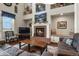 Warm living room featuring a brick fireplace, comfortable seating, and tasteful decor at 3973 Palmer Ridge Dr, Parker, CO 80134