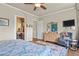 Comfortable primary bedroom with ensuite bathroom access, dresser with mirror, and cozy sitting area at 3973 Palmer Ridge Dr, Parker, CO 80134