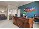 Stylish home office featuring a large desk, custom bookcase, and accent wall with mountain artwork at 3973 Palmer Ridge Dr, Parker, CO 80134