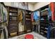 Custom walk-in closet with wood shelving, drawer storage, and space for shoes and accessories at 3973 Palmer Ridge Dr, Parker, CO 80134