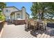 Back deck with hot tub, seating, and a view of mature trees at 9025 Rocky Mountain Ln, Parker, CO 80138