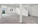 Basement with white support pillars, stairs, and access to outdoors at 9025 Rocky Mountain Ln, Parker, CO 80138