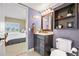 Bathroom featuring modern vanity with large mirror and cabinet with shelves at 9025 Rocky Mountain Ln, Parker, CO 80138