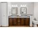 Bathroom featuring double sinks, framed mirrors, tile backsplash and tile flooring at 9025 Rocky Mountain Ln, Parker, CO 80138