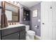 Elegant bathroom with dark vanity, granite countertop, and classic fixtures at 9025 Rocky Mountain Ln, Parker, CO 80138