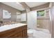 Neutral toned bathroom featuring tile finishes, single vanity, mirror, and shower at 9025 Rocky Mountain Ln, Parker, CO 80138