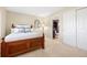 Comfortable bedroom with hardwood furniture, closet and attached bathroom at 9025 Rocky Mountain Ln, Parker, CO 80138