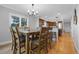 Cozy dining area adjacent to a modern kitchen featuring hardwood floors and natural light at 9025 Rocky Mountain Ln, Parker, CO 80138