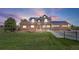 Charming brick two-story home featuring an attached garage, solar panels, and a beautifully manicured lawn at 9025 Rocky Mountain Ln, Parker, CO 80138