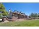 Well-maintained two-story home with brick accents, mature landscaping, and a cozy deck area for relaxation at 9025 Rocky Mountain Ln, Parker, CO 80138