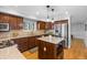 Updated kitchen with stainless steel appliances, granite countertops, and island with wine storage at 9025 Rocky Mountain Ln, Parker, CO 80138