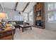 Spacious living room with vaulted ceiling, wood beams, brick fireplace and lots of natural light at 9025 Rocky Mountain Ln, Parker, CO 80138