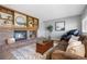Comfortable living room with a brick fireplace, wood mantel, and plenty of space for relaxation at 9025 Rocky Mountain Ln, Parker, CO 80138