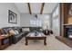 Spacious living room with vaulted ceiling, wood beams, fireplace and plantation shutters at 9025 Rocky Mountain Ln, Parker, CO 80138
