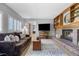 Bright living room featuring a fireplace, built-in shelves, and comfortable seating at 9025 Rocky Mountain Ln, Parker, CO 80138