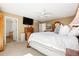 Spacious main bedroom with carpet flooring, TV, and ensuite bathroom at 9025 Rocky Mountain Ln, Parker, CO 80138