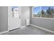 Bright mud room with durable concrete floor, white door, and a window with outdoor view at 9025 Rocky Mountain Ln, Parker, CO 80138