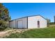 Outbuilding with a metal roof and large door at 9025 Rocky Mountain Ln, Parker, CO 80138