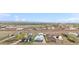 Wide aerial view capturing a residential area with expansive fields, highways, and distant mountains at 13619 Lake Ave, Brighton, CO 80603