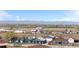 Elevated view of a residential area with mountains in the distance and commercial trucking nearby at 13619 Lake Ave, Brighton, CO 80603
