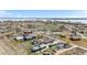 Expansive aerial shot displaying a community near a tranquil lake, interspersed with fields and roadways at 13619 Lake Ave, Brighton, CO 80603