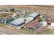 Aerial view of a neighborhood with various homes, garages and outbuildings in a rural landscape at 13619 Lake Ave, Brighton, CO 80603