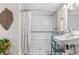Bright bathroom showcasing a clean shower with safety bars, and a modern white sink at 13619 Lake Ave, Brighton, CO 80603