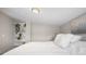 Comfortable bedroom with built-in shelving providing ample storage and decorative space at 13619 Lake Ave, Brighton, CO 80603