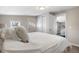 Comfortable bedroom with closet, white doors and trim, and views to other rooms at 13619 Lake Ave, Brighton, CO 80603