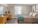 Comfortable bedroom with wooden dresser, natural light and neutral color palette at 13619 Lake Ave, Brighton, CO 80603