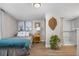 Inviting bedroom featuring an adjacent shower and neutral earth tone color palette at 13619 Lake Ave, Brighton, CO 80603