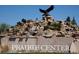 Impressive community entrance with a stunning rock waterfall and eagle statue, creating a grand welcome at 13619 Lake Ave, Brighton, CO 80603