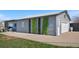 View of the property exterior, featuring siding, a garage, and decorative greenery at 13619 Lake Ave, Brighton, CO 80603