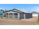 Charming home with gray siding, a fenced yard, and an inviting porch area at 13619 Lake Ave, Brighton, CO 80603