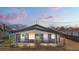 Inviting exterior of a gray home at twilight, accentuated by the soft glow of interior lights at 13619 Lake Ave, Brighton, CO 80603
