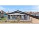 Charming gray home with a cozy, fenced front yard and inviting curb appeal at 13619 Lake Ave, Brighton, CO 80603