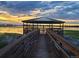 Picturesque gazebo overlooking a serene lake at sunset, offering a tranquil retreat and a scenic view at 13619 Lake Ave, Brighton, CO 80603