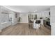 Open-concept kitchen and dining area featuring new appliances, a quartz island, and hardwood floors at 13619 Lake Ave, Brighton, CO 80603