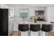 Modern kitchen with stainless steel appliances, quartz island, and black barstools at 13619 Lake Ave, Brighton, CO 80603