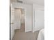 Neutral bedroom with sliding closet and open doorway to hallway, carpeted for comfort at 11228 Bella Vita Dr, Broomfield, CO 80020