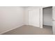 A clean, carpeted bedroom featuring a sliding closet and doorway to an adjacent room at 11228 Bella Vita Dr, Broomfield, CO 80020
