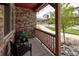 A cozy covered front porch with decorative stone and seating provides a relaxing outdoor space at 11228 Bella Vita Dr, Broomfield, CO 80020