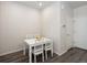 The dining room features a white table and chairs set on hardwood floors with natural light coming in at 11228 Bella Vita Dr, Broomfield, CO 80020