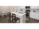 The modern kitchen features a center island with quartz countertops, stainless steel appliances, and sleek cabinetry at 11228 Bella Vita Dr, Broomfield, CO 80020
