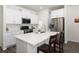 Modern kitchen boasts stainless steel appliances, quartz countertops, and ample cabinet space for storage at 11228 Bella Vita Dr, Broomfield, CO 80020