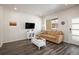 Bright living room featuring stylish flooring, a comfortable couch, and ample natural light for a cozy atmosphere at 11228 Bella Vita Dr, Broomfield, CO 80020