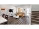 Well-lit living room featuring modern flooring, neutral decor, and staircase offering a cozy and inviting atmosphere at 11228 Bella Vita Dr, Broomfield, CO 80020