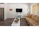 Modern living room with stylish gray floors, a comfortable sofa, and neutral walls providing a bright, inviting space at 11228 Bella Vita Dr, Broomfield, CO 80020