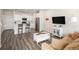 Open-concept living space with modern flooring, kitchen with bar seating, and a comfortable living area for gatherings at 11228 Bella Vita Dr, Broomfield, CO 80020